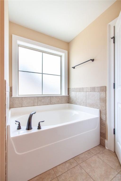 bathroom featuring tile patterned flooring and a tub