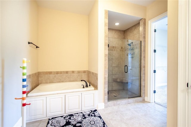 bathroom featuring tile patterned flooring and independent shower and bath