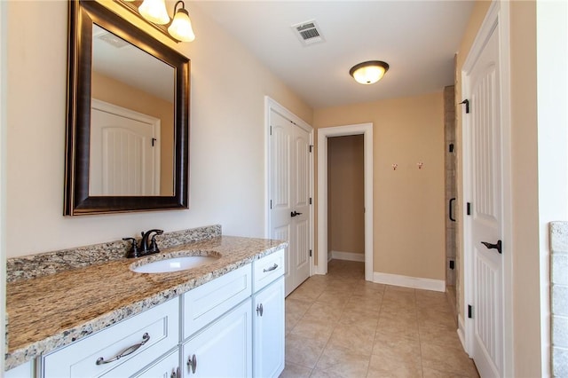 bathroom featuring tile patterned floors, vanity, and walk in shower