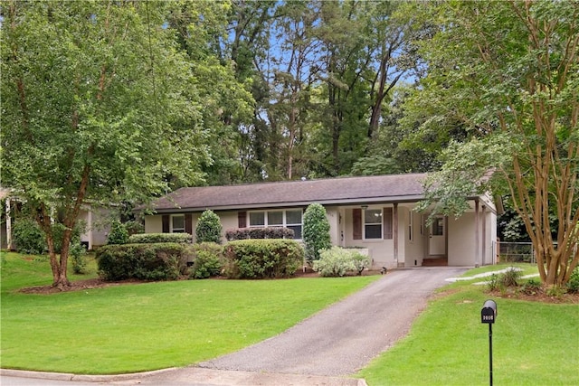 1016 E Magnolia Ave, Auburn, AL 36830 - ranch-style house with driveway, an attached carport, and stucco siding