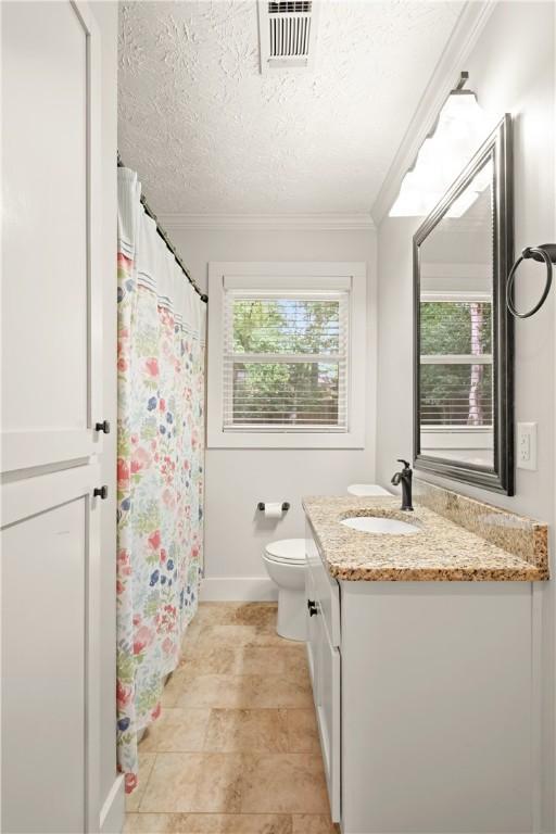 1016 E Magnolia Ave, Auburn, AL 36830 - full bathroom with vanity, ornamental molding, a shower with curtain, and a textured ceiling
