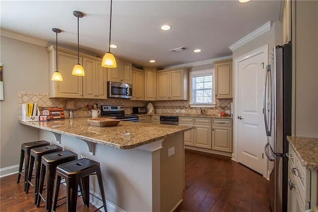 kitchen featuring light stone countertops, kitchen peninsula, a breakfast bar, stainless steel appliances, and hanging light fixtures