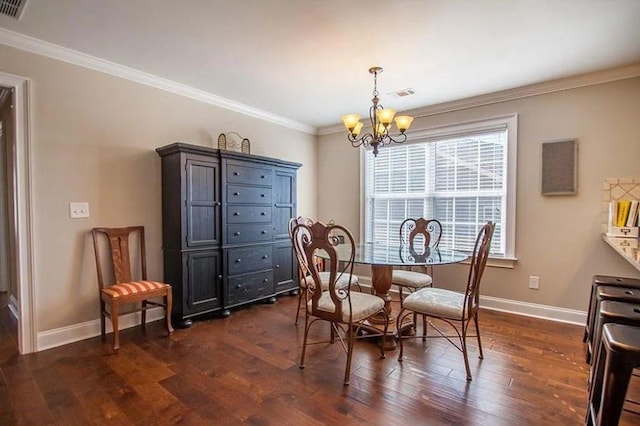 dining room with a chandelier, dark wood-type flooring, and ornamental molding