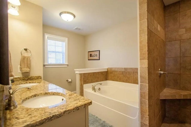 bathroom with vanity and a tub to relax in