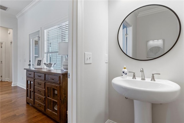 2260 Pam Cir, Auburn, AL 36832 - bathroom with ornamental molding, wood finished floors, baseboards, and a sink