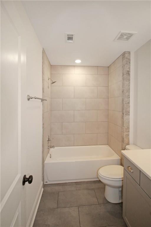 full bathroom with tile patterned floors, toilet, vanity, and tiled shower / bath