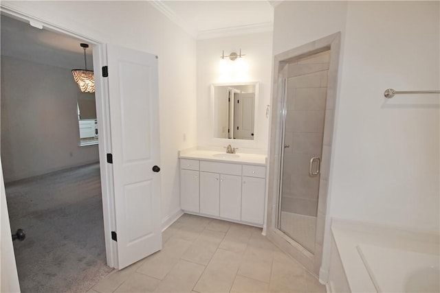 bathroom featuring vanity, crown molding, a shower with door, and tile patterned flooring