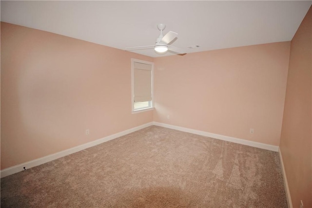 carpeted empty room featuring ceiling fan