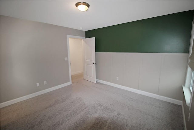 unfurnished room featuring carpet