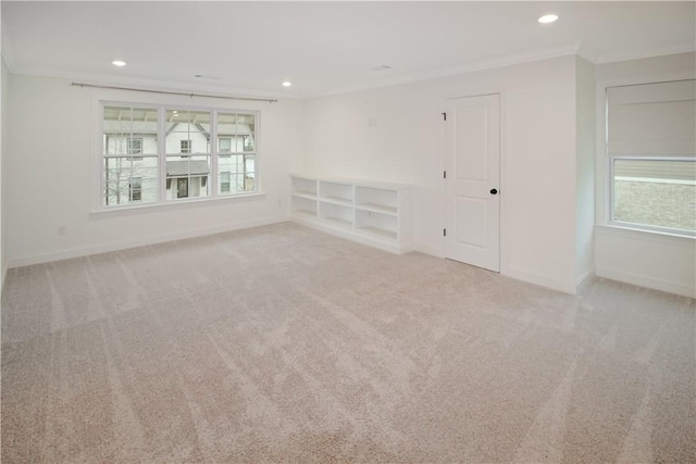 unfurnished room with crown molding and light carpet