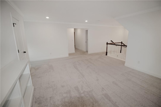 empty room with light colored carpet and crown molding