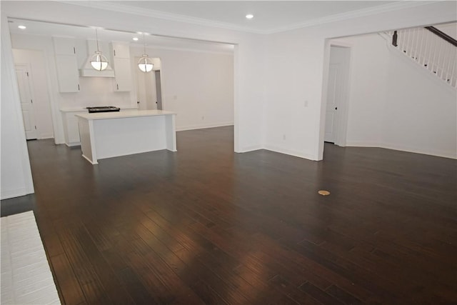 unfurnished living room featuring crown molding and dark hardwood / wood-style floors