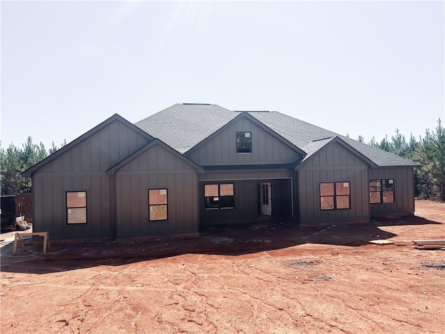 view of front of home with board and batten siding and roof with shingles