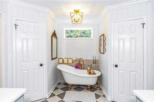 bathroom featuring a notable chandelier, a washtub, ornamental molding, and vanity