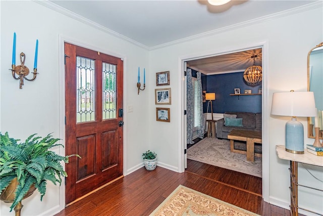 entrance foyer featuring an inviting chandelier, crown molding, and dark wood-type flooring