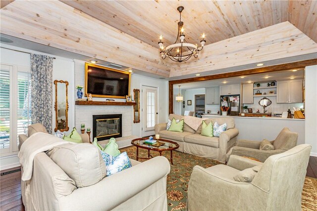 living room with a chandelier, hardwood / wood-style floors, a raised ceiling, and wooden ceiling