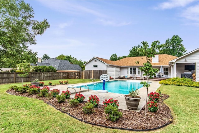 view of pool featuring a patio and a lawn