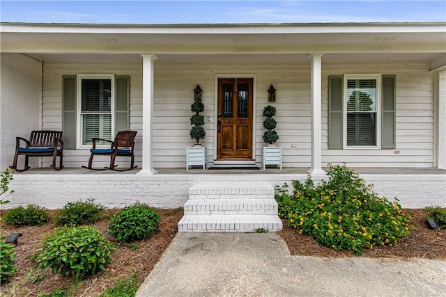 view of exterior entry featuring a porch