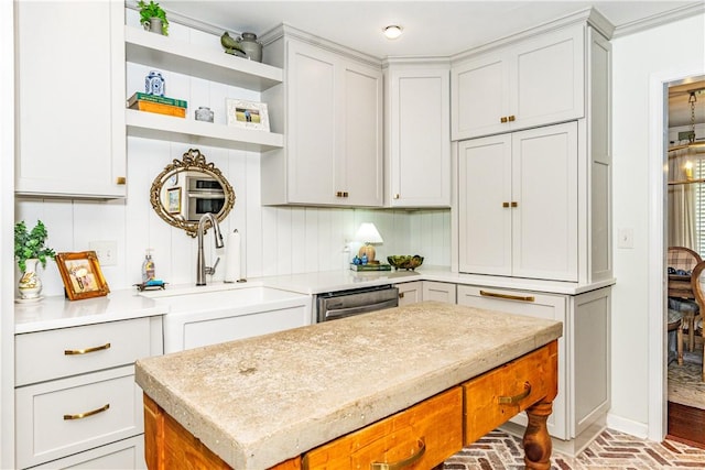 kitchen featuring a center island, sink, stainless steel dishwasher, tasteful backsplash, and light stone counters