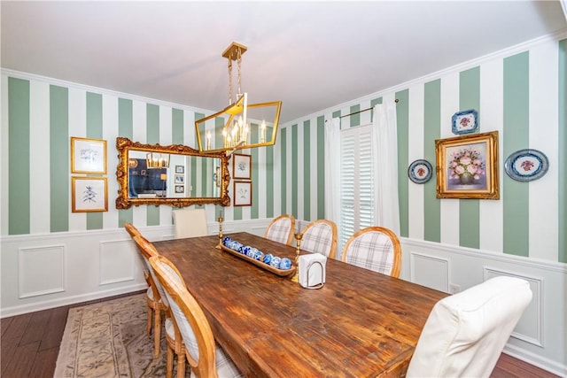 dining room featuring an inviting chandelier, ornamental molding, and hardwood / wood-style flooring