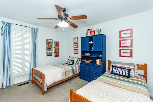 carpeted bedroom with ceiling fan and ornamental molding