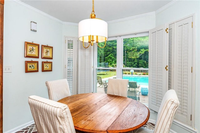 dining area featuring crown molding and a notable chandelier