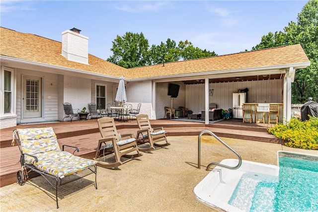 view of patio featuring a bar and a swimming pool side deck