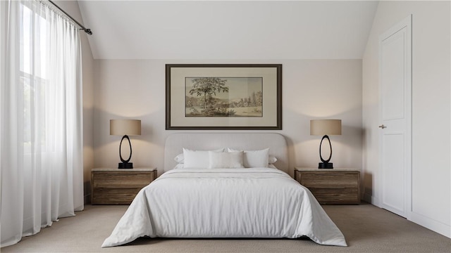 carpeted bedroom with lofted ceiling