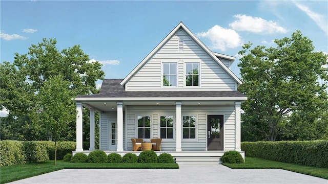 view of front of home with covered porch and a front yard