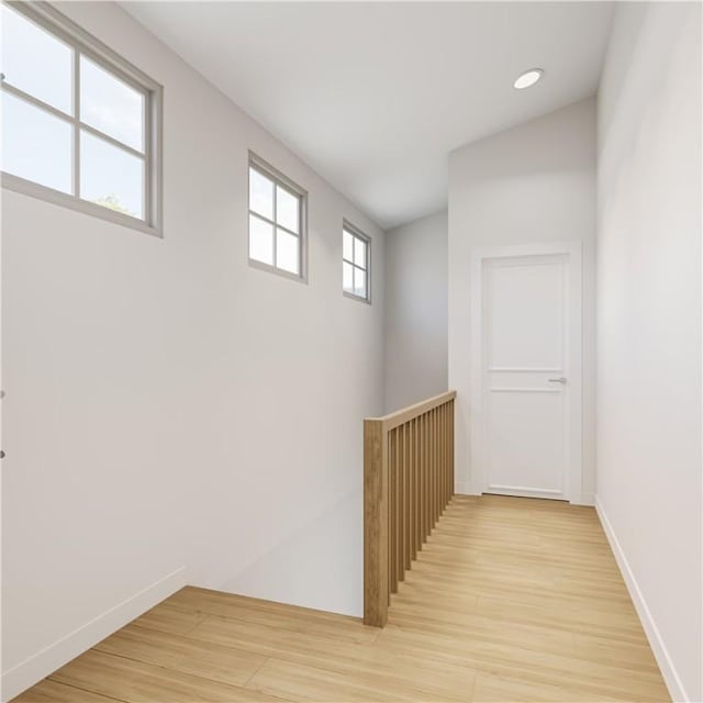 hallway with light hardwood / wood-style flooring