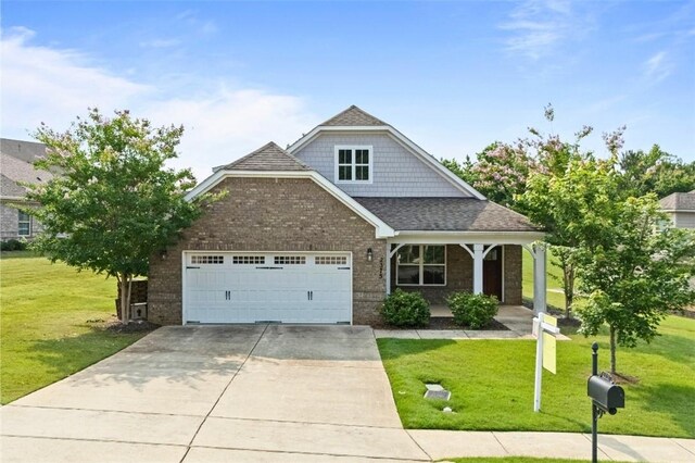 2375 Snowshill Ln, Auburn, AL 36832 - view of front of property with a garage, driveway, a front yard, and brick siding