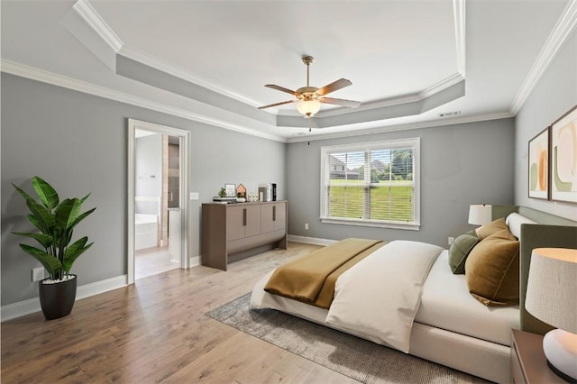 2375 Snowshill Ln, Auburn, AL 36832 - bedroom with a raised ceiling, wood finished floors, crown molding, ensuite bathroom, and baseboards