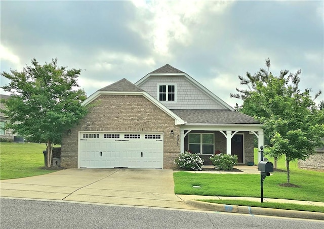 2375 Snowshill Ln, Auburn, AL 36832 - view of front of home featuring an attached garage, driveway, a front yard, brick siding, and a shingled roof