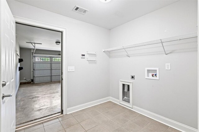 2375 Snowshill Ln, Auburn, AL 36832 - laundry room with hookup for a washing machine, electric dryer hookup, baseboards, and a garage
