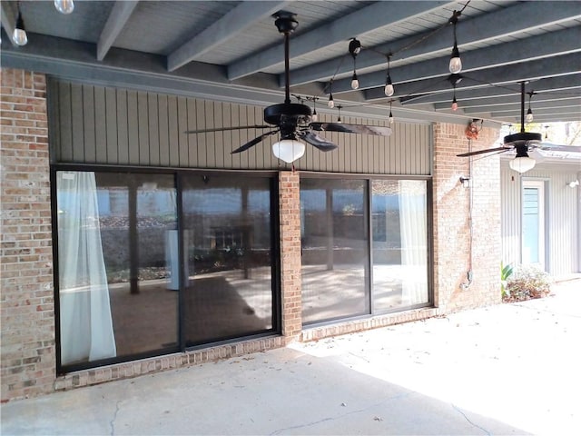 entrance to property featuring ceiling fan and a patio area