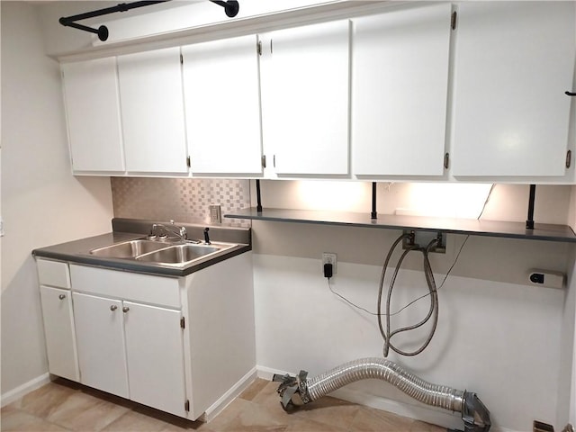 clothes washing area featuring cabinets, hookup for an electric dryer, and sink