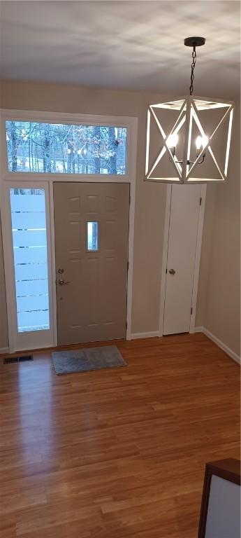 foyer featuring a notable chandelier and hardwood / wood-style floors