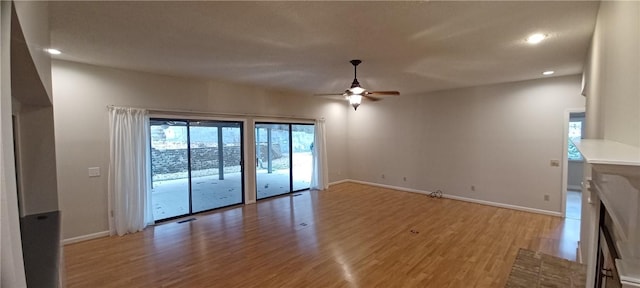 unfurnished living room with ceiling fan and hardwood / wood-style floors