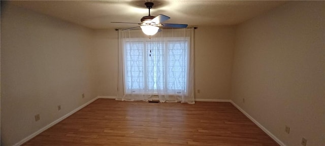 empty room featuring ceiling fan and hardwood / wood-style flooring