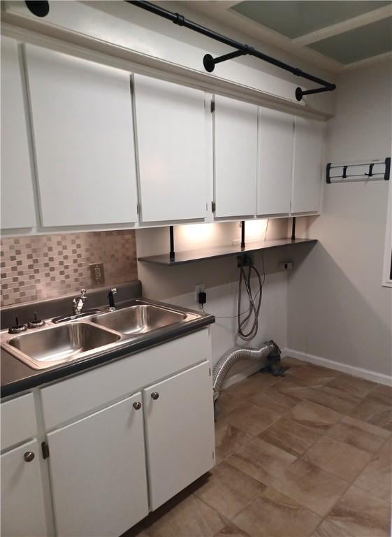 kitchen with white cabinets, tasteful backsplash, and sink