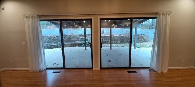 doorway to outside with a healthy amount of sunlight and wood-type flooring