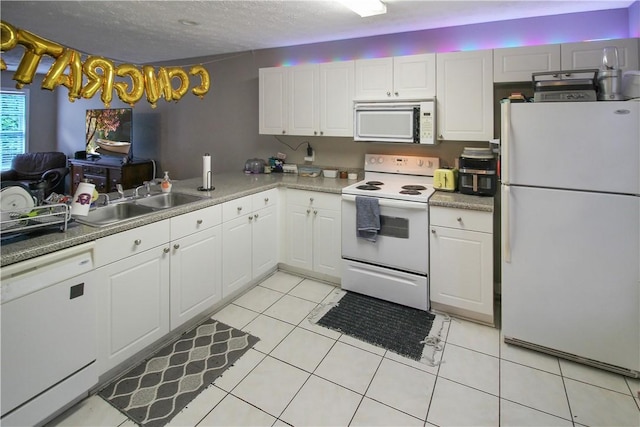 1477 N Donahue Dr Unit 3905, Auburn, AL 36830 - kitchen with white appliances, white cabinets, a sink, light tile patterned floors, and light countertops