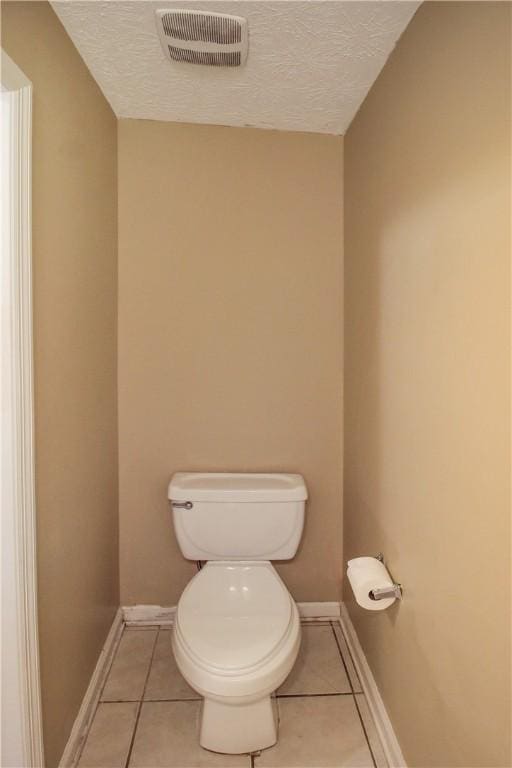 1477 N Donahue Dr Unit 3905, Auburn, AL 36830 - bathroom with tile patterned flooring, toilet, a textured ceiling, and baseboards