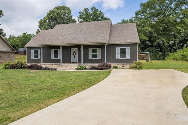 160 Indian Ln, Tallassee, AL 36078 - view of front of property with a porch, a shingled roof, and a front lawn