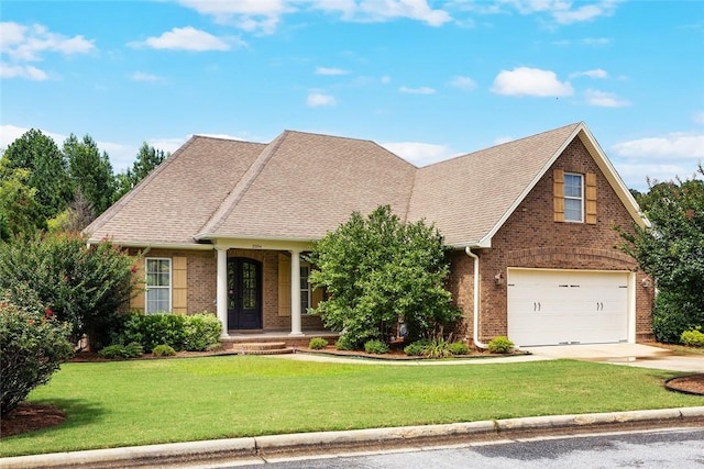 3204 Pinecrest Dr, Opelika, AL 36801 - view of front of home with brick siding, driveway, a front lawn, an attached garage, and a shingled roof