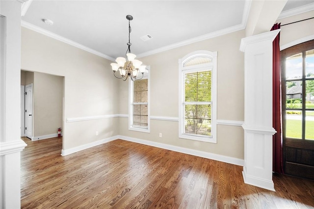 3204 Pinecrest Dr, Opelika, AL 36801 - empty room featuring wood finished floors, ornamental molding, a chandelier, ornate columns, and a smoke detector