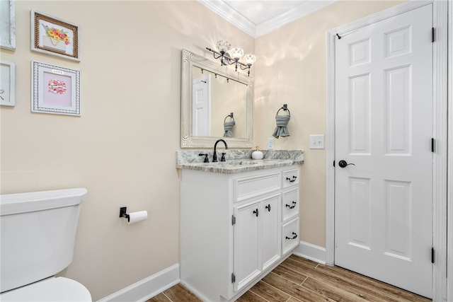 601 Overlook Dr, Opelika, AL 36801 - bathroom featuring wood finished floors, ornamental molding, toilet, vanity, and baseboards