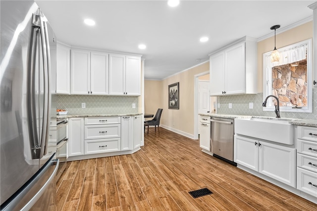 601 Overlook Dr, Opelika, AL 36801 - kitchen featuring baseboards, ornamental molding, backsplash, and appliances with stainless steel finishes