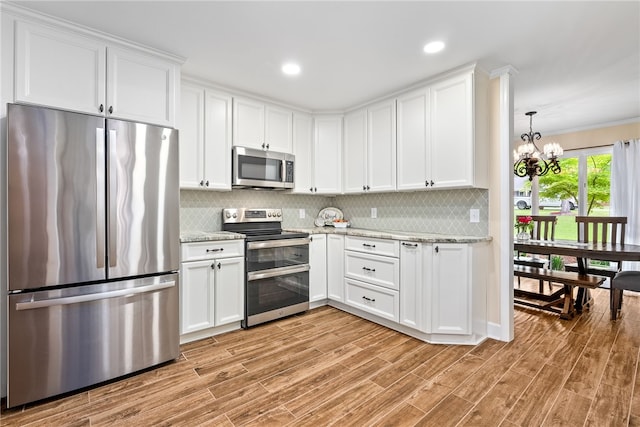 601 Overlook Dr, Opelika, AL 36801 - kitchen with stainless steel appliances, white cabinets, and backsplash