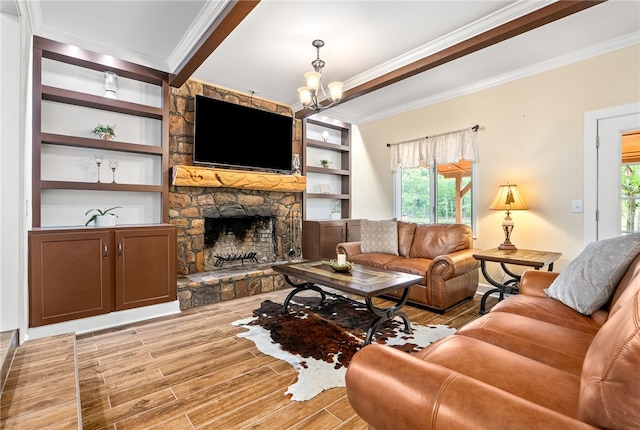 601 Overlook Dr, Opelika, AL 36801 - living room with a notable chandelier, built in shelves, light wood-style floors, crown molding, and a stone fireplace